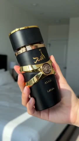 Close-up of the black-and-gold fragrance bottle in an existing AI-generated Moras video