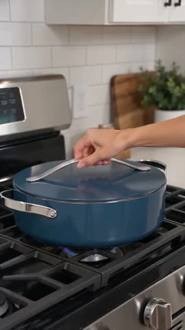 Blue lidded cookware on a stovetop in an existing AI-generated Moras video