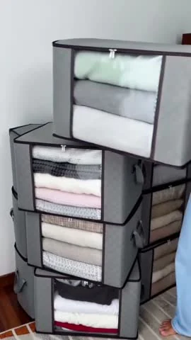 Moras AI video frame showing folded clothing in stacked storage boxes